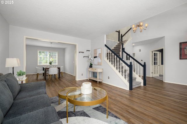 6783 Apollo Rd, West Linn, OR 97068 - living area with stairs, a chandelier, wood finished floors, baseboards, and a textured ceiling