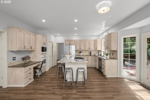 6783 Apollo Rd, West Linn, OR 97068 - kitchen featuring stainless steel appliances, a sink, light brown cabinets, a kitchen breakfast bar, and recessed lighting