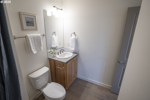 2368 Kingwood St, Forest Grove, OR 97116 - full bathroom with wood finished floors, toilet, vanity, and baseboards