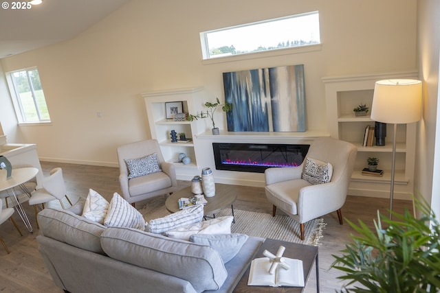 2368 Kingwood St, Forest Grove, OR 97116 - living area with a glass covered fireplace, wood finished floors, high vaulted ceiling, and baseboards