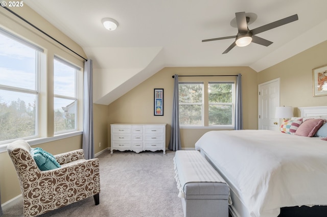 carpeted bedroom featuring ceiling fan, lofted ceiling, and multiple windows