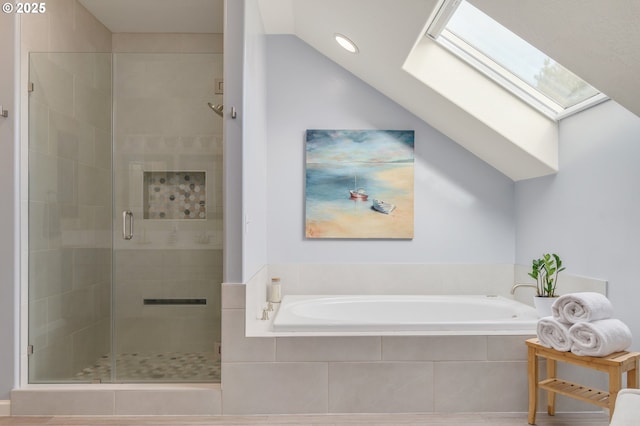 bathroom featuring lofted ceiling with skylight and plus walk in shower