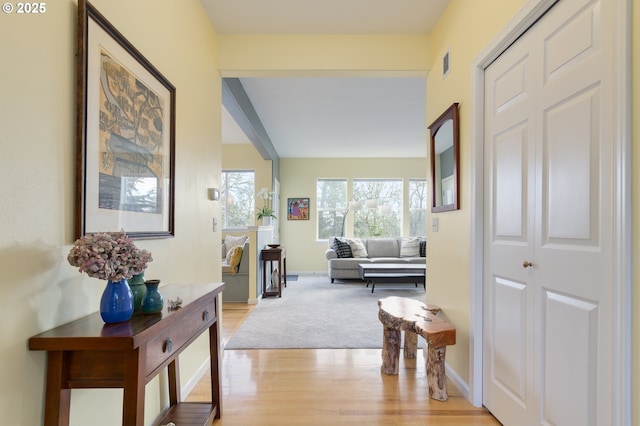 hallway with light hardwood / wood-style floors