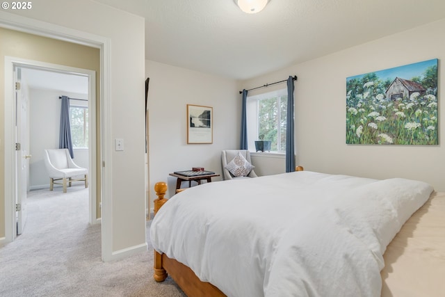 bedroom featuring light carpet