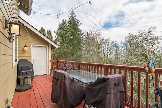 wooden terrace featuring a grill