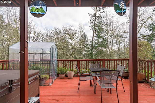 wooden terrace featuring an outbuilding