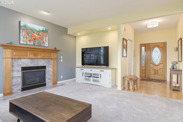 living room with light colored carpet and a tiled fireplace