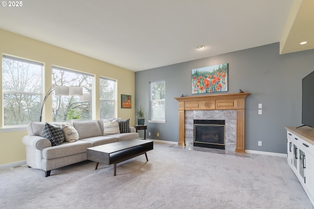 living room featuring a fireplace and light colored carpet