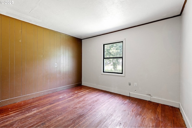 36285 Row River Rd, Cottage Grove, OR 97424 - unfurnished room with wood-type flooring, wooden walls, and ornamental molding