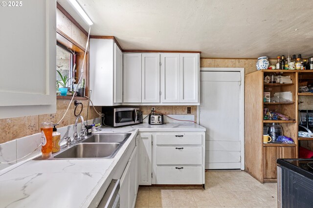 36285 Row River Rd, Cottage Grove, OR 97424 - kitchen with stainless steel microwave, white cabinets, stove, light stone counters, and light tile patterned floors
