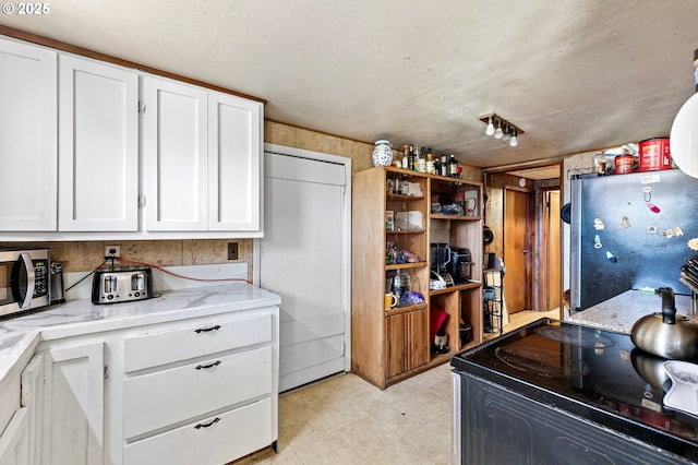 36285 Row River Rd, Cottage Grove, OR 97424 - kitchen with appliances with stainless steel finishes, white cabinets, and light stone counters