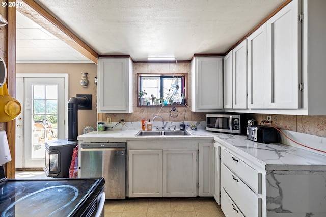 36285 Row River Rd, Cottage Grove, OR 97424 - kitchen featuring stainless steel appliances, plenty of natural light, white cabinets, and a textured ceiling