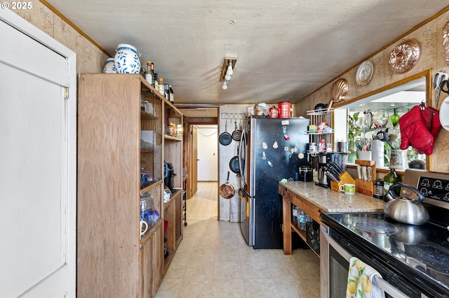 36285 Row River Rd, Cottage Grove, OR 97424 - kitchen with appliances with stainless steel finishes, a textured ceiling, and light tile patterned floors