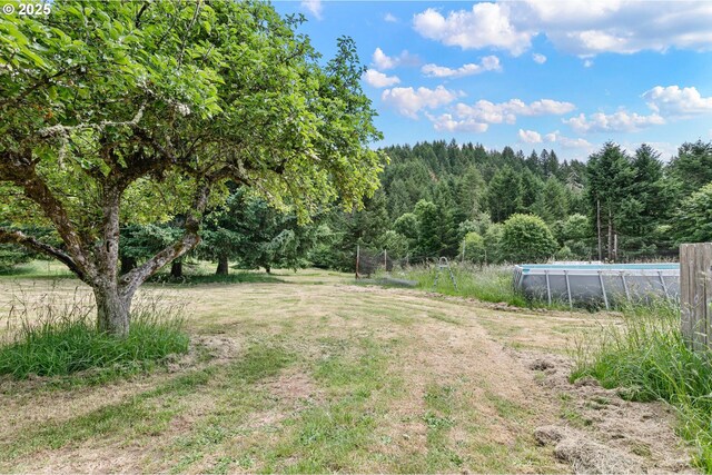 36285 Row River Rd, Cottage Grove, OR 97424 - view of yard featuring an outdoor pool and a forest view