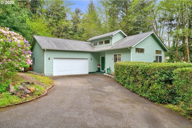 3347 31st St, Florence, OR 97439 - view of front of house featuring a garage, driveway, and a shingled roof
