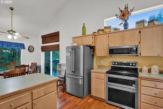 3347 31st St, Florence, OR 97439 - kitchen featuring light brown cabinetry, light countertops, stainless steel appliances, a ceiling fan, and light wood-type flooring
