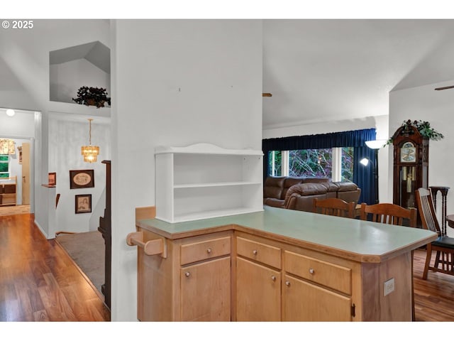 kitchen with light countertops, open shelves, wood finished floors, and open floor plan