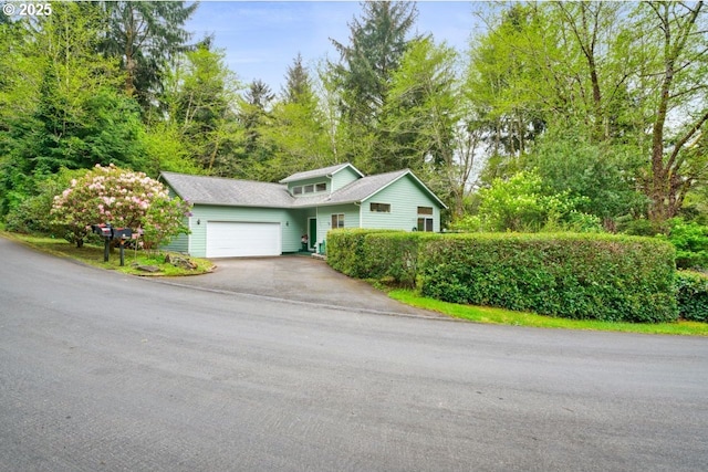 3347 31st St, Florence, OR 97439 - view of front of house featuring an attached garage and aphalt driveway