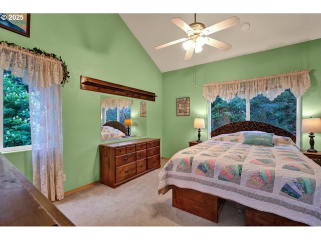 carpeted bedroom with high vaulted ceiling, ceiling fan, and baseboards