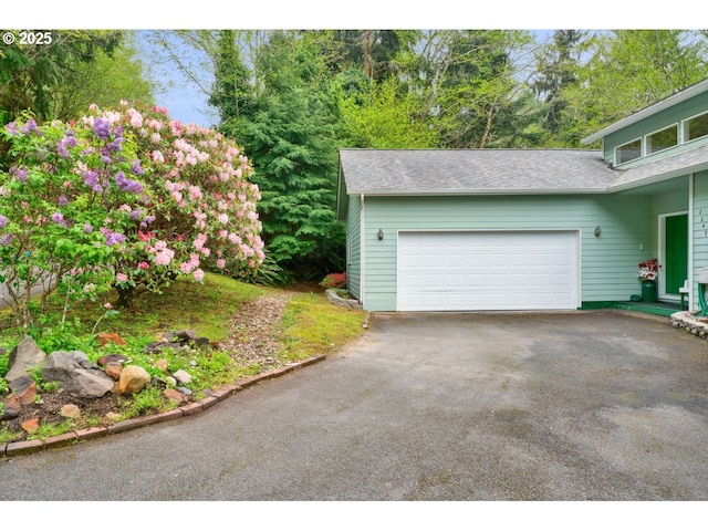 garage with aphalt driveway