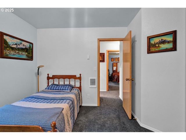bedroom with baseboards and dark colored carpet