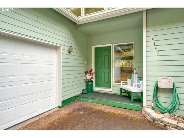 view of exterior entry featuring a garage