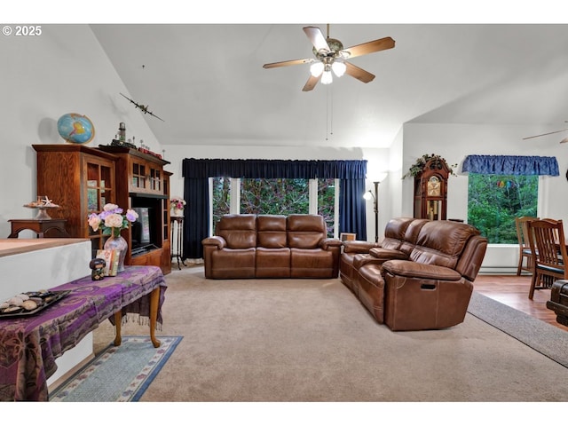 living area with ceiling fan, a wealth of natural light, and high vaulted ceiling