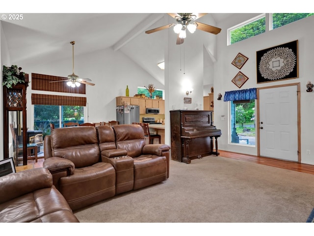 living room featuring light colored carpet, ceiling fan, a healthy amount of sunlight, and high vaulted ceiling