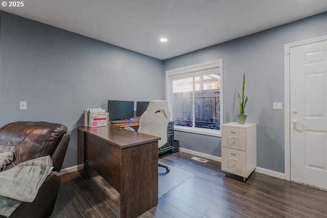 office area featuring visible vents, dark wood finished floors, and baseboards