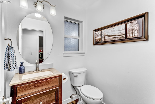 half bathroom featuring toilet and vanity