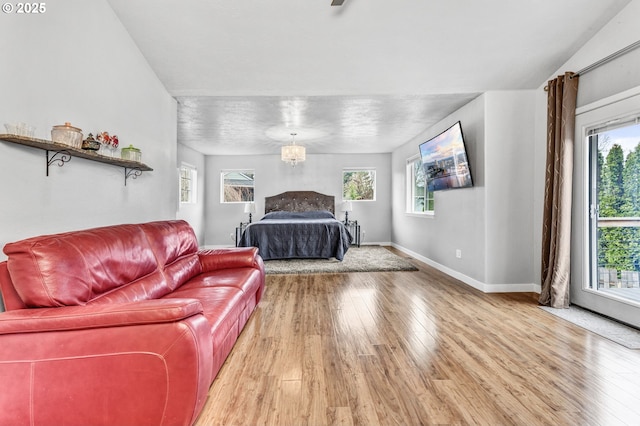 unfurnished bedroom with light wood-style flooring, baseboards, and multiple windows