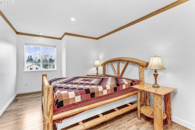 bedroom featuring recessed lighting, ornamental molding, baseboards, and wood finished floors