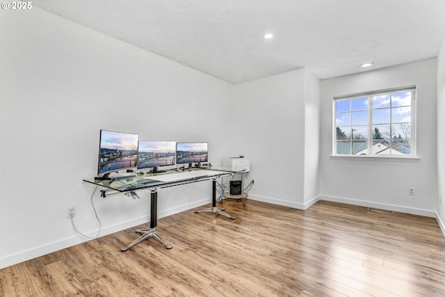 home office featuring recessed lighting, visible vents, baseboards, and wood finished floors