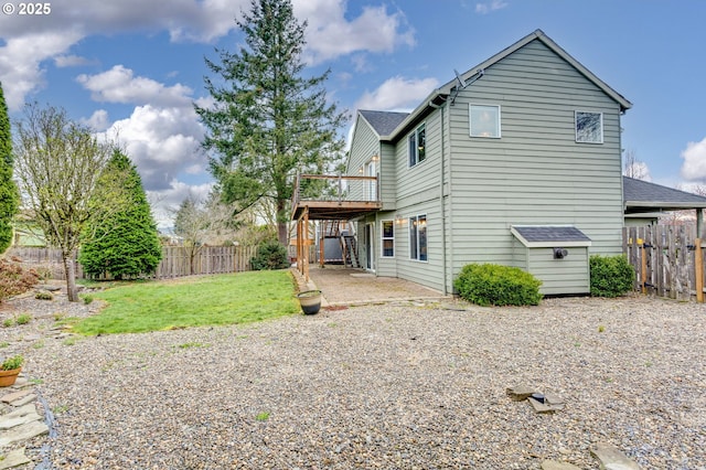 back of property featuring a yard, a patio, a fenced backyard, and a deck