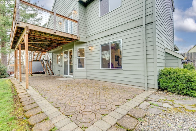 view of patio featuring a deck and stairway