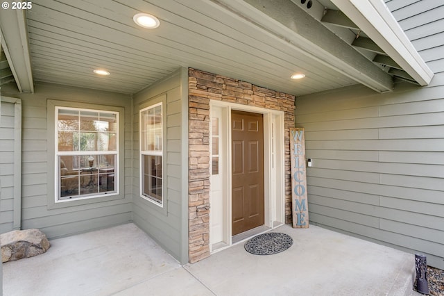 property entrance with stone siding