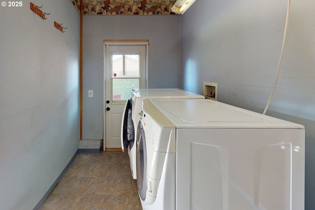 washroom featuring independent washer and dryer and baseboards