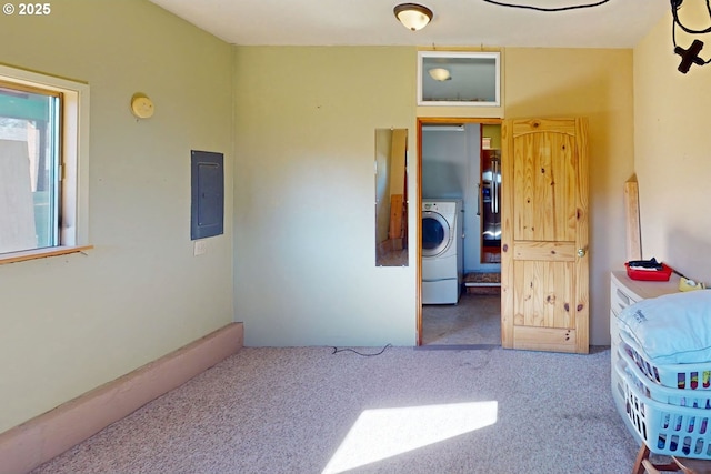 carpeted bedroom with electric panel and washer / clothes dryer