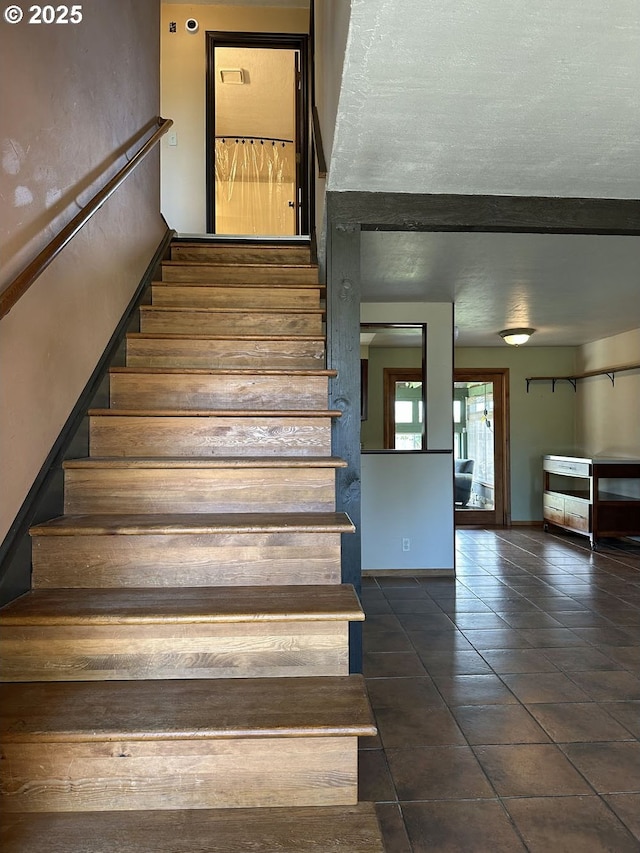 staircase featuring tile patterned flooring