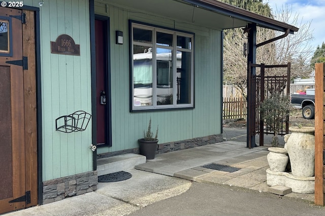 entrance to property featuring fence
