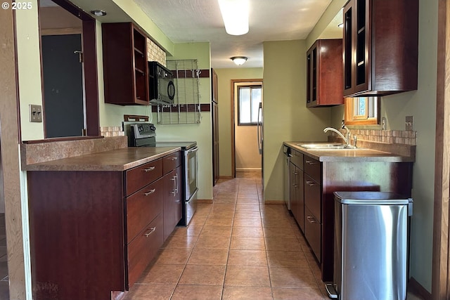 kitchen with electric range, black microwave, a sink, baseboards, and open shelves