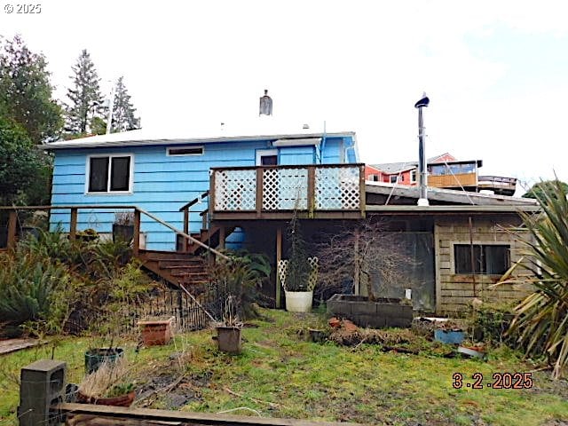 back of house with stairs and a wooden deck