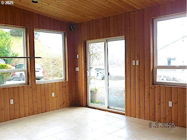 entryway featuring wood walls, wood ceiling, and vaulted ceiling