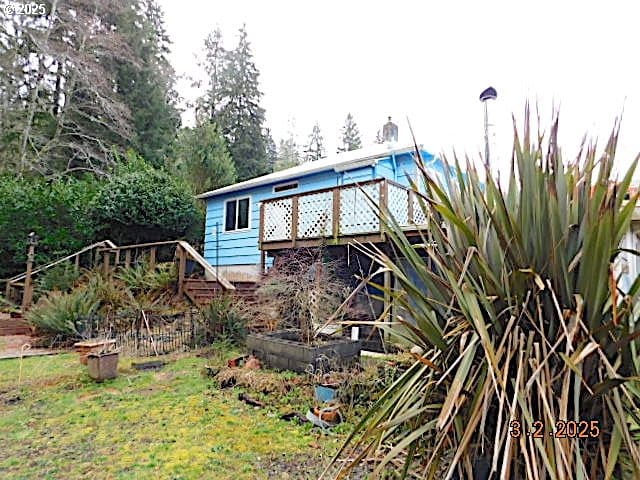 back of house featuring a deck