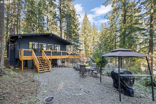 exterior space featuring a wooden deck and a gazebo