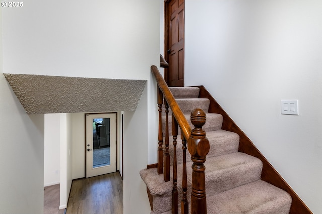 staircase featuring hardwood / wood-style flooring