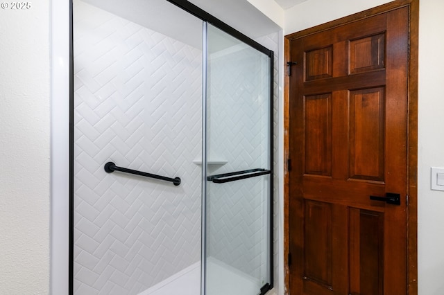 bathroom with a shower with door