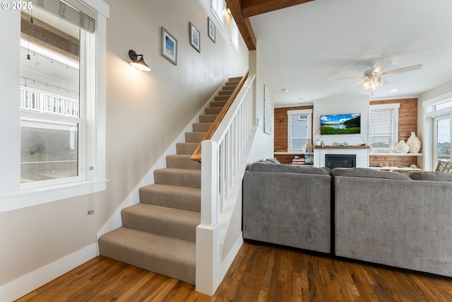 2539 SW Coral Loop, Lincoln City, OR 97367 - living area with stairs, dark wood-style flooring, a ceiling fan, a fireplace, and recessed lighting