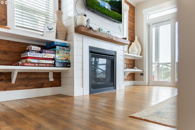 2539 SW Coral Loop, Lincoln City, OR 97367 - unfurnished living room with wood finished floors and a multi sided fireplace