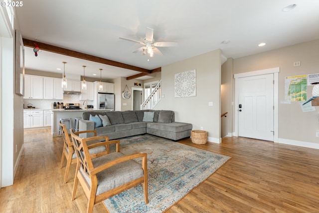 2539 SW Coral Loop, Lincoln City, OR 97367 - living area with light wood-style flooring, stairs, recessed lighting, ceiling fan, and beamed ceiling